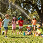 Child drinking water outdoors during summer play in San Antonio
