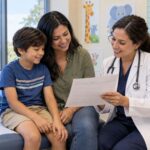 Parent and child reviewing an immunization record with a healthcare provider before school starts.